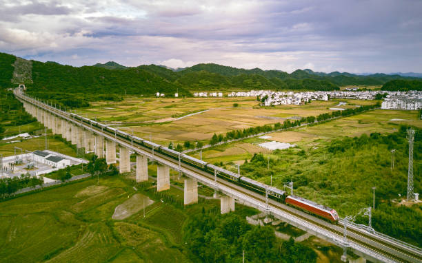 Dandong, China - Sep 06, 2014: A group of North Korean citizens and a Japanese tourist wait for their documents to be processed before the departure of the train to Pyongyang. Dandong station is located just a few kilometres from the Chinese-North Korean border. Only very few trusted DPRK citizens enjoy the privilege of travel to foreign countries.