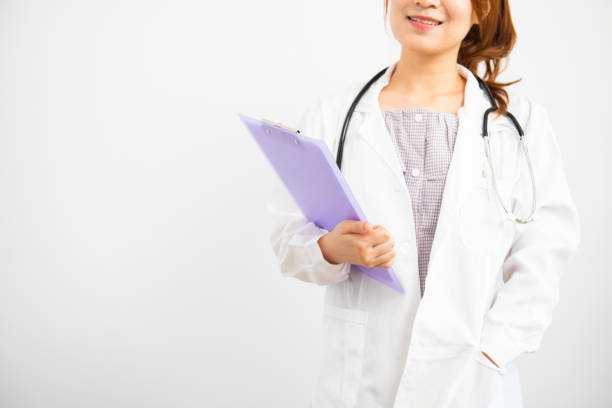 istock Young female doctor standing on white background 1071992410