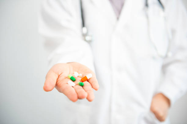 istock Young female doctor standing on white background 1071992442