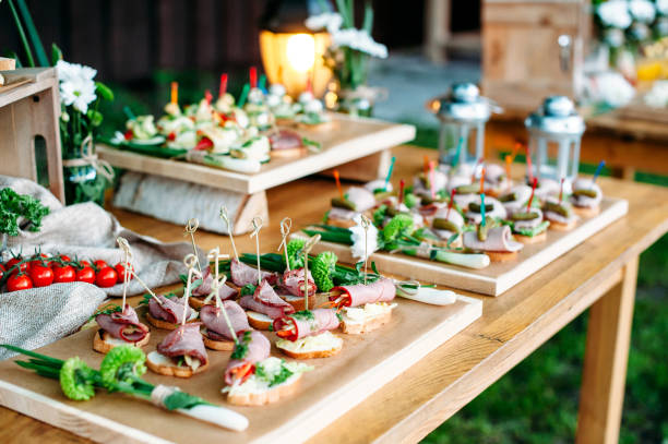 istock Beautiful catering banquet table decorated in rustic style. Different snacks and sandwiches. Soft focus. 1072005122