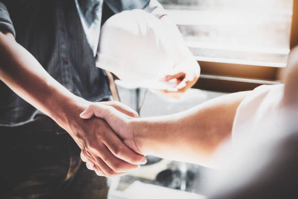 business cooperation, construction, design agreement concept. handshake between designer engineers - respect imagens e fotografias de stock