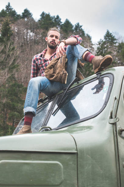 istock Young man on vintage truck with logs 1072019320