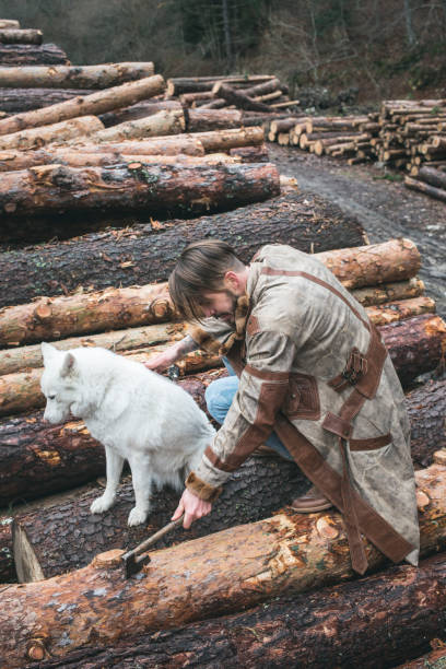 istock Young man and dog on logs in the forest 1072021686