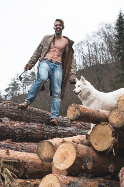 istock Young man and dog on logs in the forest 1072021786