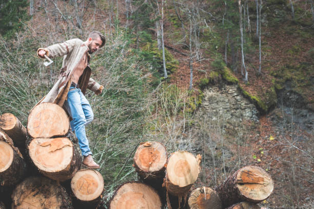 istock Young man and dog on logs in the forest 1072021832