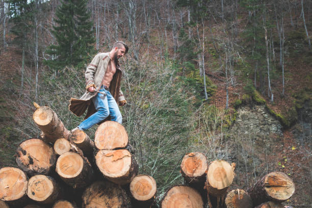 istock Young man and dog on logs in the forest 1072021850
