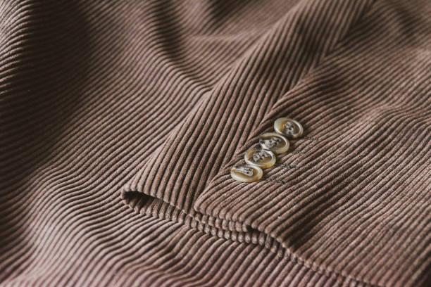 brown corduroy sleeve jacket with four buttons brown corduroy sleeve jacket with four buttons. velvet fabric texture corduroy jacket stock pictures, royalty-free photos & images