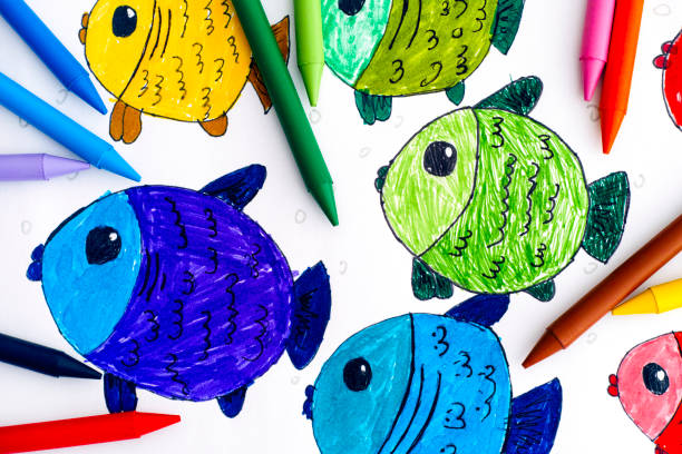 istock Multicolored fishes. Child hand drawing with colored crayons. 1072028086