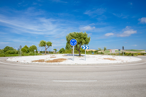 blue roundabout traffic signal in lonely rural road in of Spain, Europe