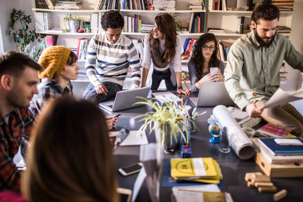 istock Group of multi-tasking creative people working on a meeting in the office. 1072036384