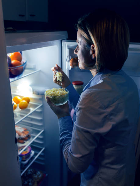istock Woman looking at food in refrigerator 1072036526