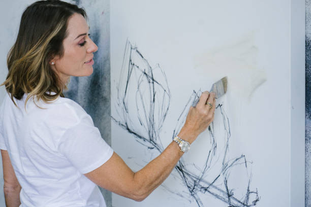 istock Woman painting canvas in art studio 1072037692