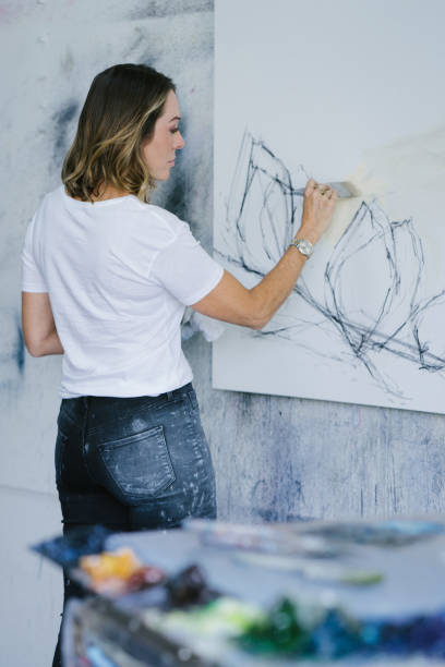 istock Woman painting canvas in art studio 1072037836