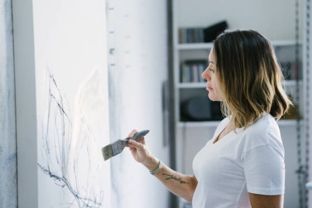 istock Woman painting canvas in art studio 1072037926