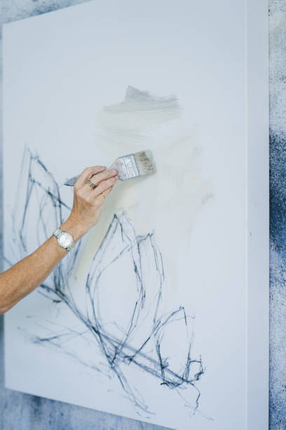 istock Woman painting canvas in art studio 1072037972
