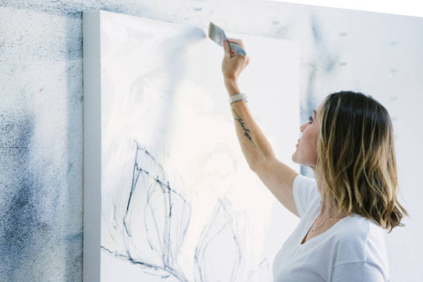 istock Woman painting canvas in art studio 1072038164