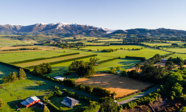 istock Farmland with snow peaked mountains in background. 1072039934