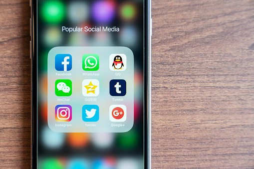 BANGKOK,THAILAND - OCTOBER 5th, 2018 : iPhone with icon of popular social media app are trendy in 2018. Facebook, Whatsapp, QQ, WeChat, QZone, Tumblr, Instagram, Twitter, Google+ app are on screen