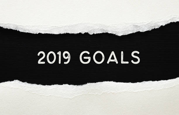 istock 2019 goals list written over torn paper on black background. 1072042192