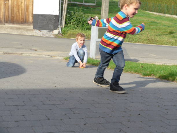 istock two rebel brothers playing on the driveway 1072044230