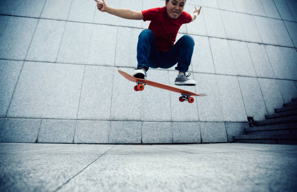 istock Skateboarder doing ollie at city 1072049922