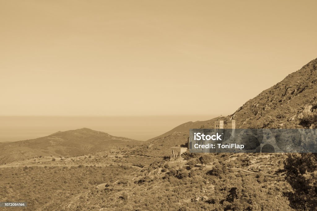 View on the abbey of Sant Pere de Rodes, Catalonia, Spain. View on the abbey of Sant Pere de Rodes and the Port de la Selva at the Costa Brava, Catalonia, Spain. Ancient Stock Photo