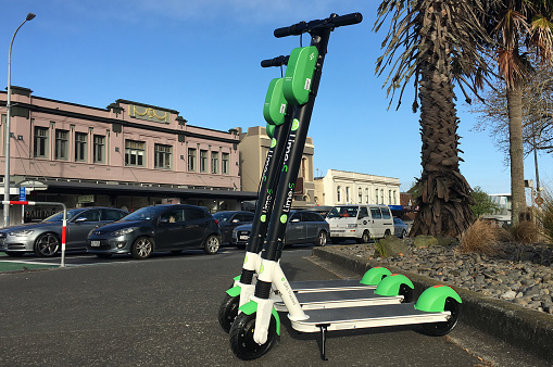 AUCKLAND - OCT 15 2018: Lime electric scooters in Auckland, New Zealand. The scooters have a 48km maximum range. Users find, unlock and pay for them using an app and leave them at their destination.