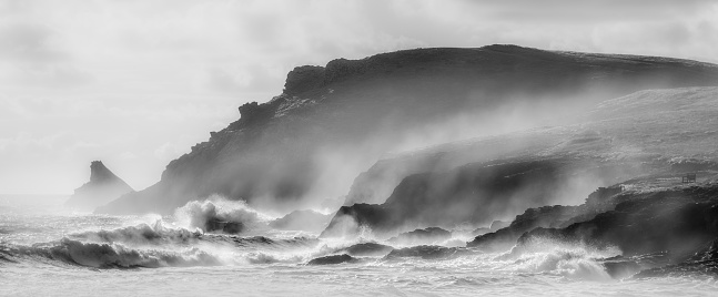 Atlantic gales batter the coastal location of Trevose Head in Cornwall. Image captured in black and white.