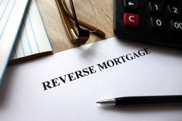 istock Reverse mortgage document with pen, calculator and glasses on desk 1072058954