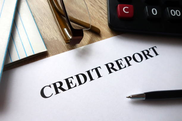 istock Credit report document with pen, calculator and glasses on desk 1072060194