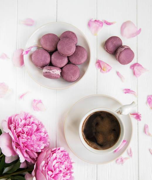 istock Pink peony with coffee and macarons 1072060294