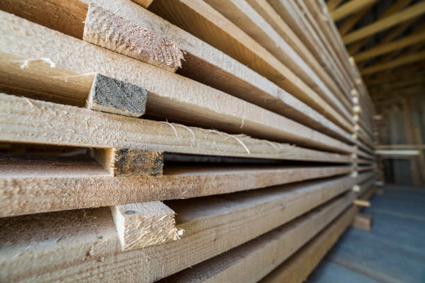 istock Neatly piled long stack of wooden boards inside attic room under construction. 1072060870
