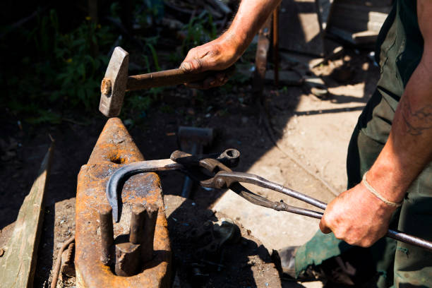 istock Blacksmith with a hammer on the anvil works 1072061328