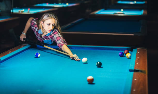 istock Young woman playing pool 1072065068
