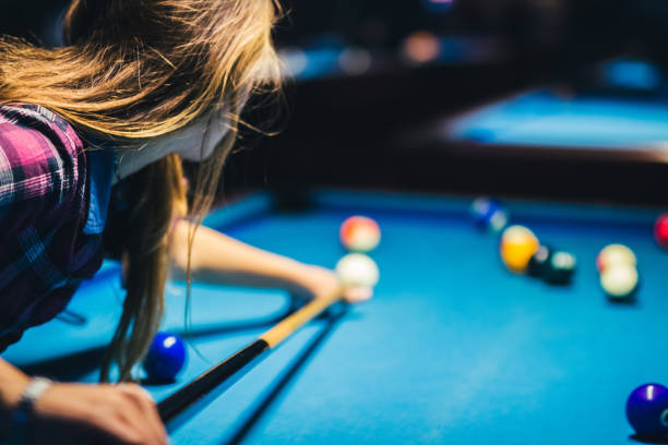 istock Young woman playing pool 1072065402