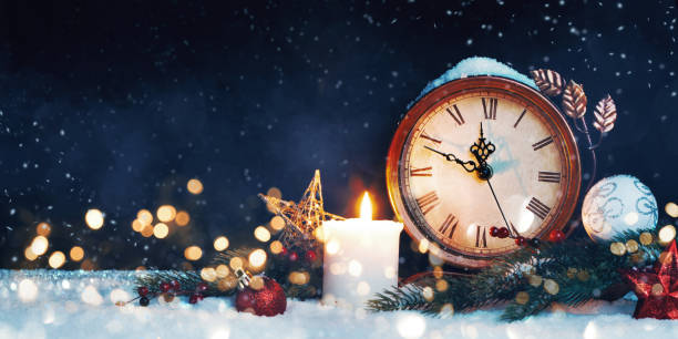 istock New Year's clock. Decorated with balls, star and tree on snow 1072067768