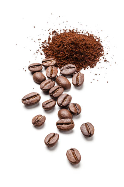 istock Coffee beans and ground coffee heap isolated on white background 1072068024