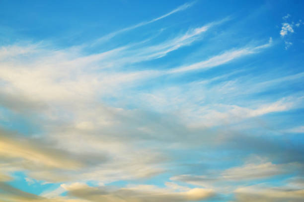 istock Wavy, porous curly clouds in the blue sky. Nature Background. Dramatic sky. 1072071784