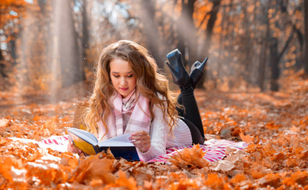 istock Girl in autumn forest at sunny day 1072073472