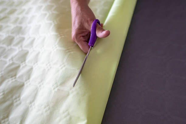 istock Elderly Woman Hand Cutting Paper With Scissors 1072074192