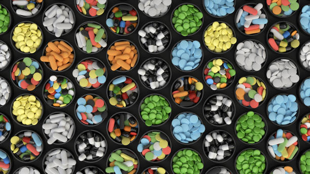 istock Colorful drug pills in lids 1072074228