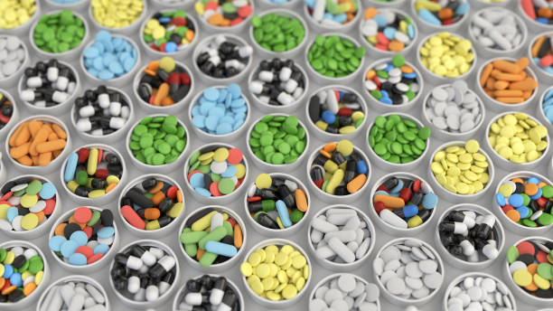 istock Colorful drug pills in lids 1072074290