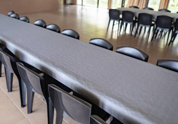 istock Row Of Tables And Chairs With Grey Paper Tablecloths 1072074364