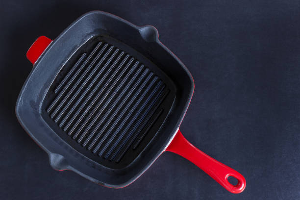 istock Empty red grill pan on black background. Copy space. Concept- cooking, menu, recipes. 1072074386