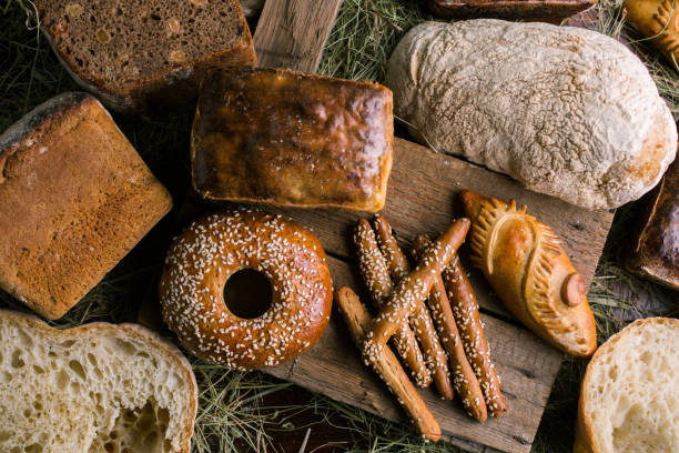 istock Delicious bread and breadsticks on wooden table 1072076194