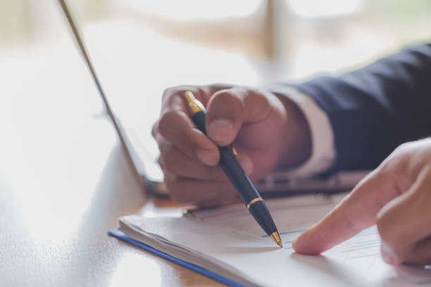 istock Two businessmen analyzing stats financial data on pc laptop, pointing at screen with rising graph and charts, discussing company growth, 1072076824