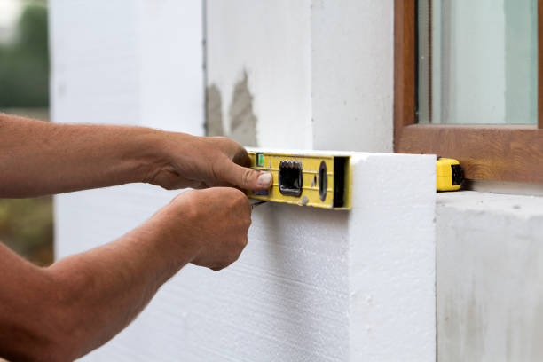 istock Worker hand with level and knife measuring and cutting white rigid polyurethane foam sheet on wall at newly installed plastic window. Modern technology, renovation, insulation concept. 1072077162