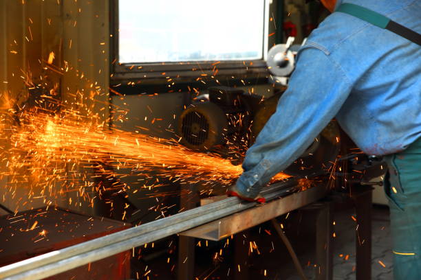 istock Cutting steel with a stationary grinder in a locksmith's workshop. 1072079206