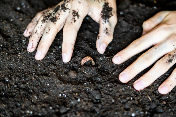 istock finding a precious golden ring in the soil ground f 1072079234
