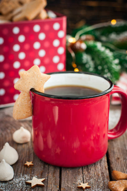 istock Red tea mug with cookies in Christmas decorations on a wooden table, selective focus 1072084208